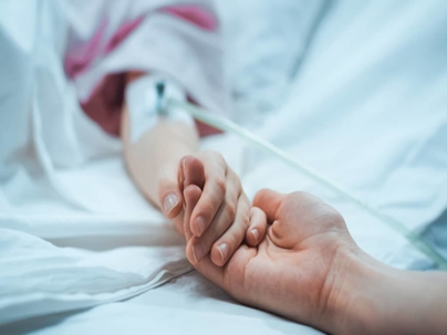 holding hands with a hospital patient